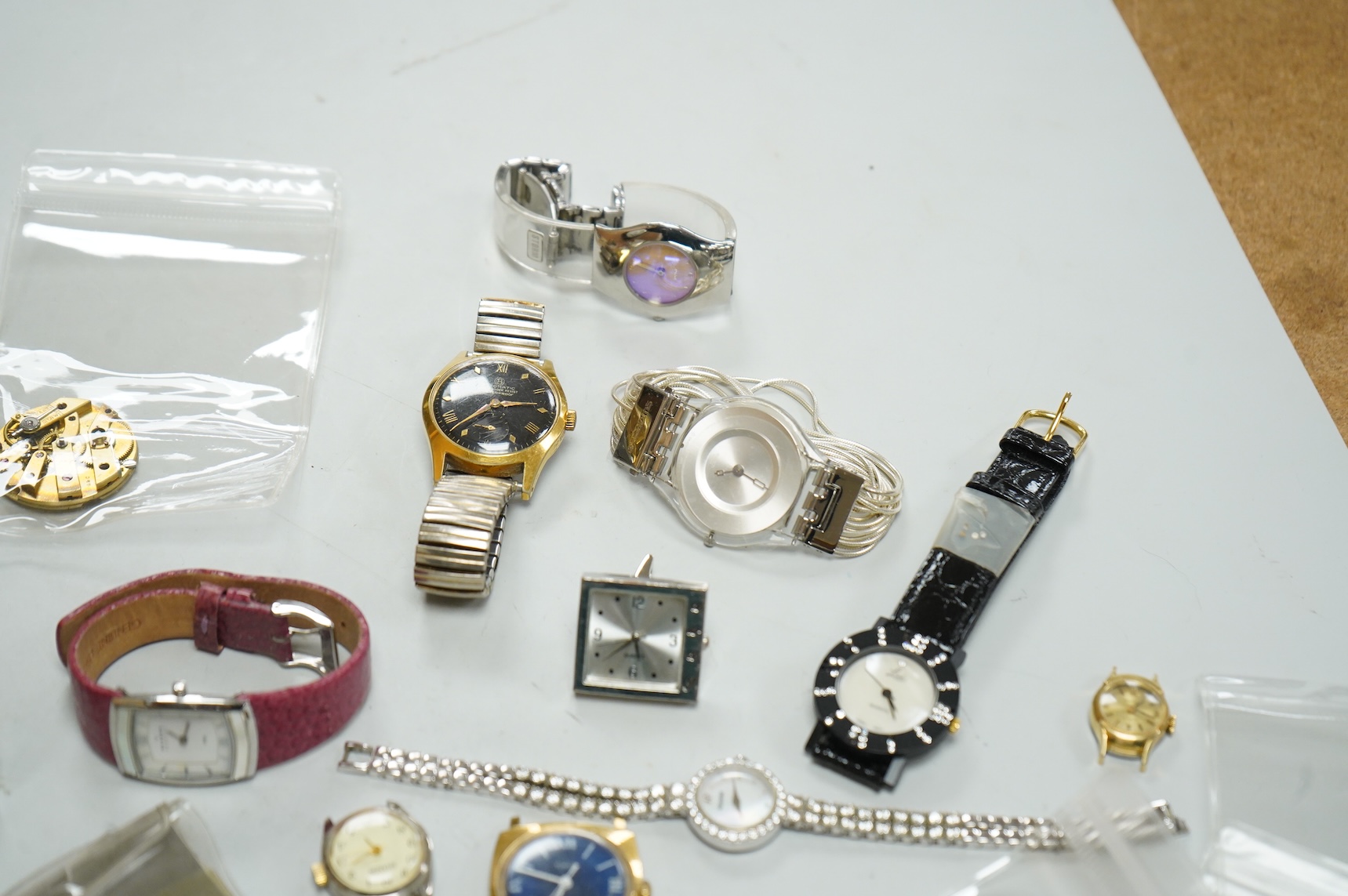 A small collection of assorted lady's and gentleman's wrist watches, including three Omega De Ville steel and gold plated quartz watches and wrist watches movements including Girard Perregaux.